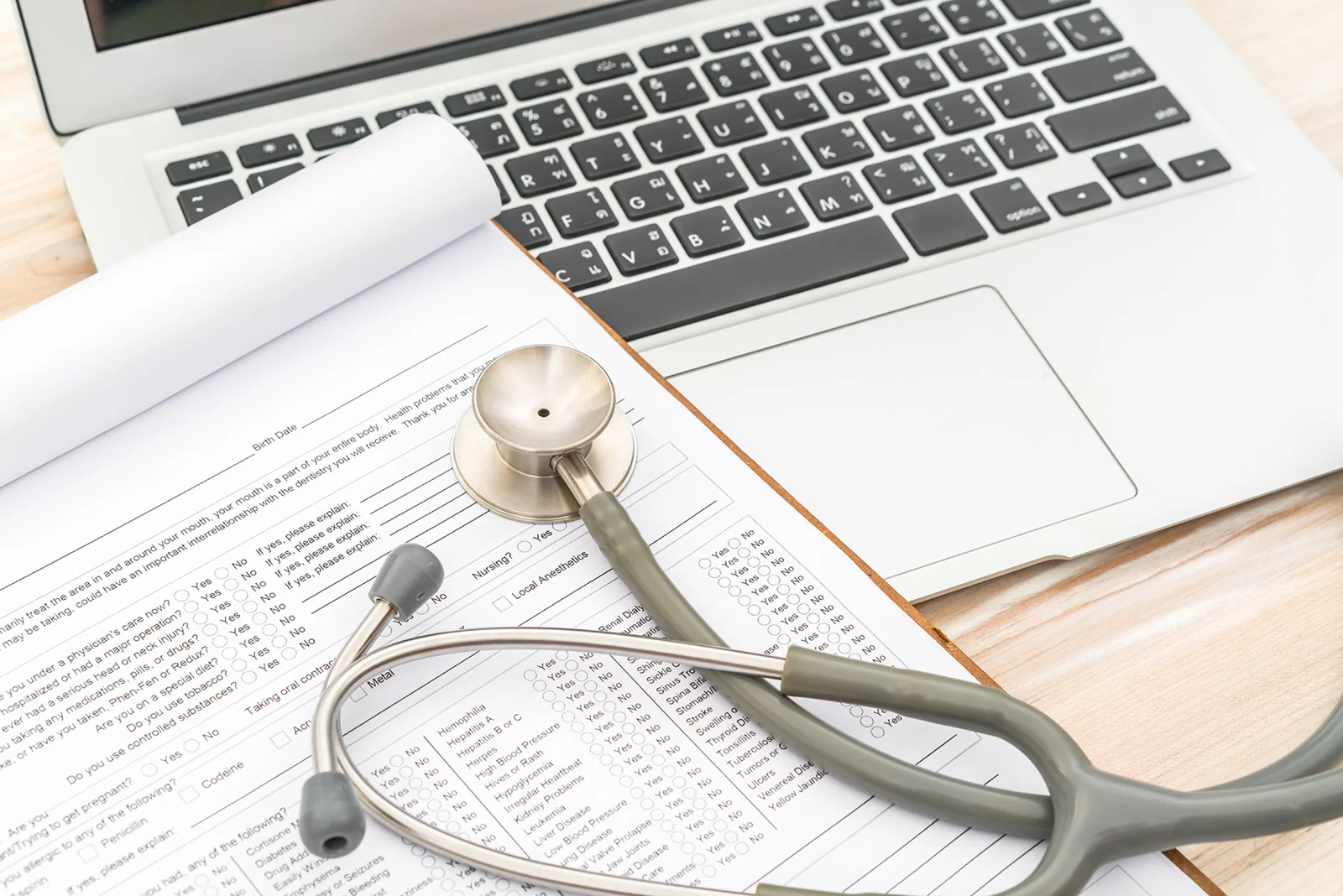Stethoscope, medical records and laptop